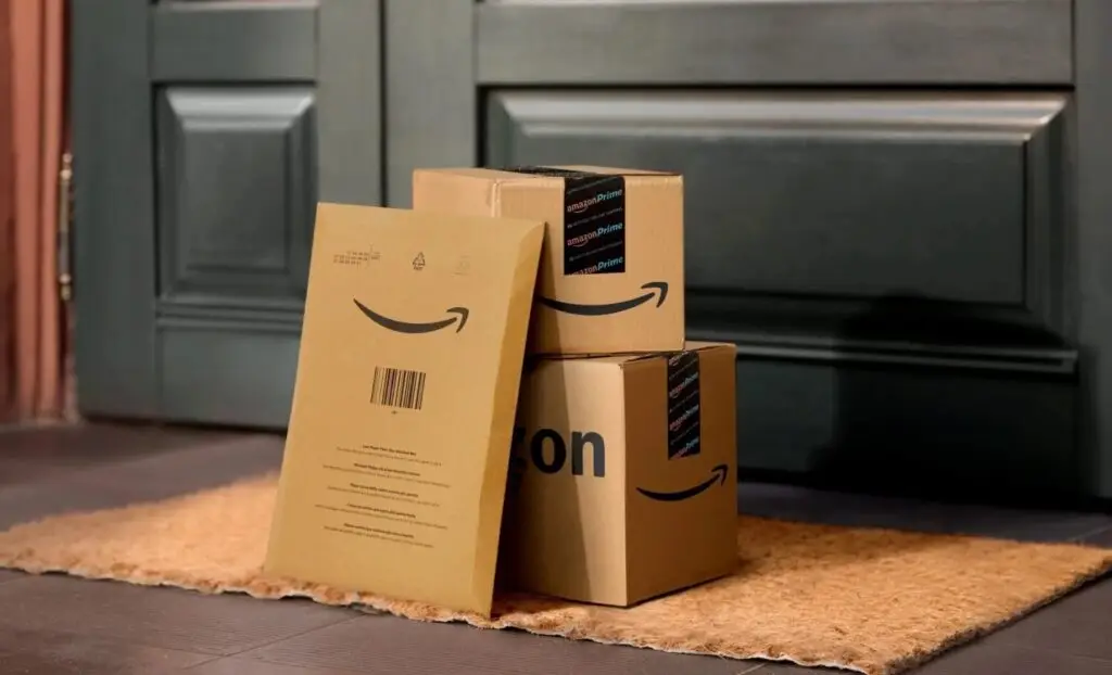 pile of Amazon boxes on a doorstep